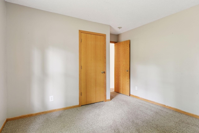 2070 Racine Ave S, Lake Saint Croix Beach, MN 55043 - unfurnished bedroom featuring carpet flooring and baseboards