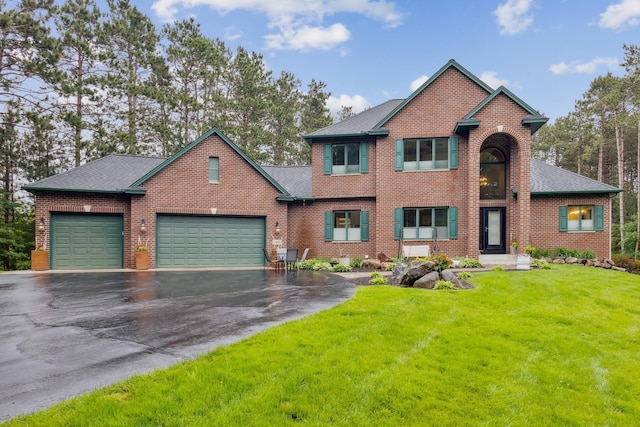 26659 145th St NW, Zimmerman, MN 55398 - view of front of home featuring driveway, an attached garage, a front lawn, brick siding, and a shingled roof