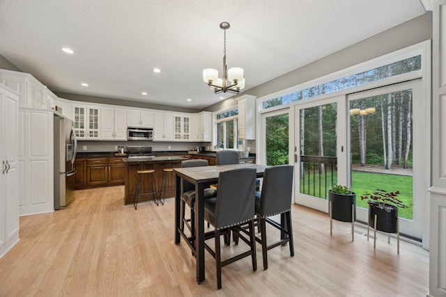 26659 145th St NW, Zimmerman, MN 55398 - dining area with light wood-style flooring, a chandelier, recessed lighting, and french doors