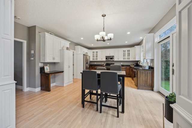 26659 145th St NW, Zimmerman, MN 55398 - dining room featuring a chandelier, light wood finished floors, a textured ceiling, and recessed lighting