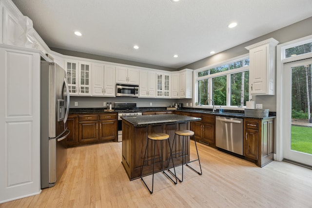 26659 145th St NW, Zimmerman, MN 55398 - kitchen with appliances with stainless steel finishes, light wood-style floors, a kitchen island, recessed lighting, and a breakfast bar