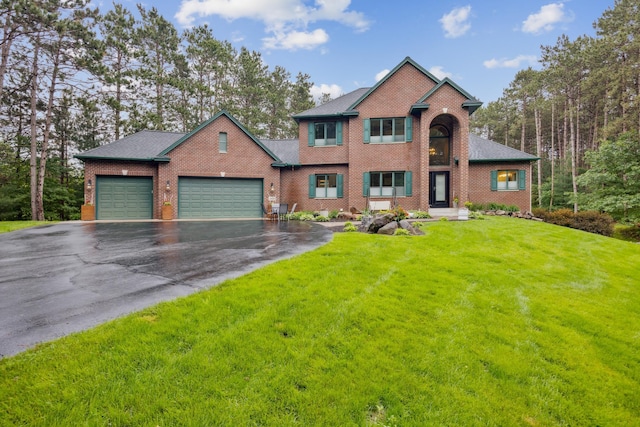 26659 145th St NW, Zimmerman, MN 55398 - view of front facade featuring a garage, asphalt driveway, brick siding, and a front lawn
