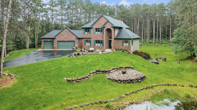 26659 145th St NW, Zimmerman, MN 55398 - view of front facade featuring a garage, asphalt driveway, brick siding, a front lawn, and a shingled roof