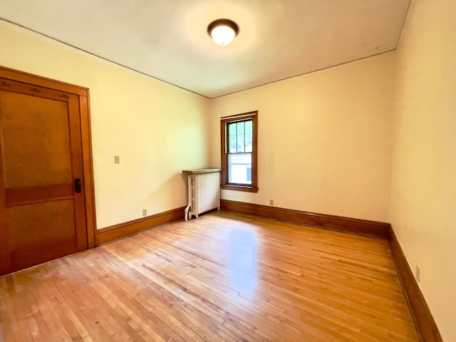 2411 Como Ave, Saint Paul, MN 55108 - empty room with radiator and light wood-style flooring