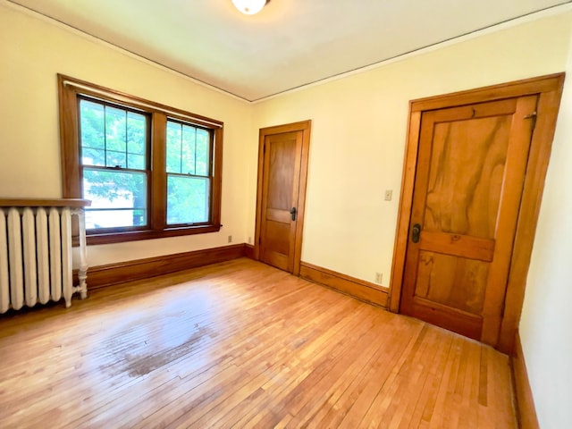 2411 Como Ave, Saint Paul, MN 55108 - unfurnished room featuring radiator heating unit and light wood-type flooring