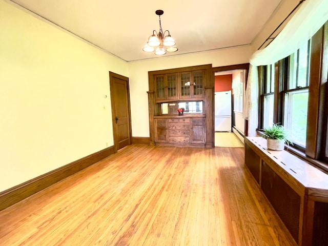 2411 Como Ave, Saint Paul, MN 55108 - unfurnished dining area with baseboard heating, a chandelier, and light wood-style floors