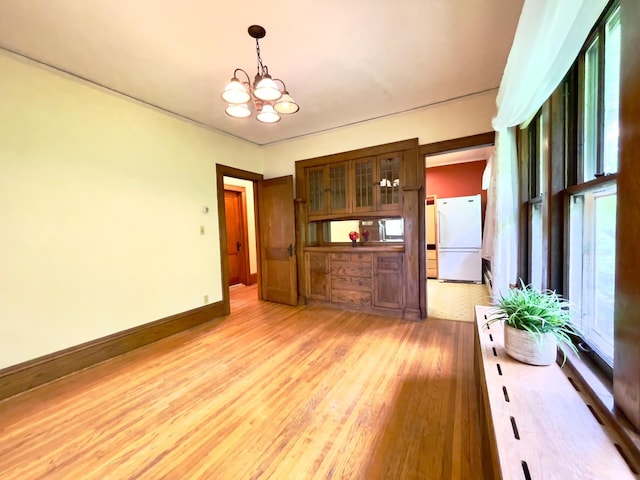 2411 Como Ave, Saint Paul, MN 55108 - unfurnished dining area with a chandelier and light wood finished floors
