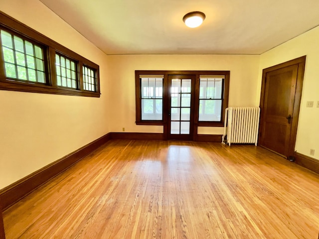 2411 Como Ave, Saint Paul, MN 55108 - empty room with radiator heating unit and light wood finished floors