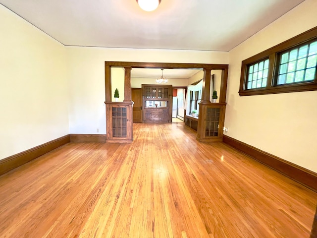 2411 Como Ave, Saint Paul, MN 55108 - unfurnished living room with a chandelier, plenty of natural light, and light wood-style flooring