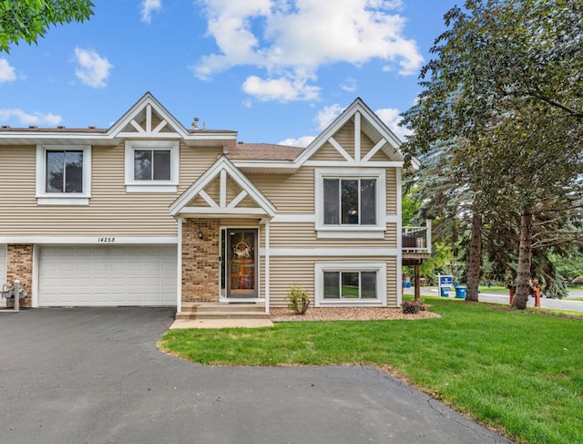 14258 Towers Ln, Eden Prairie, MN 55347 - view of front facade with a front lawn, a garage, brick siding, and driveway