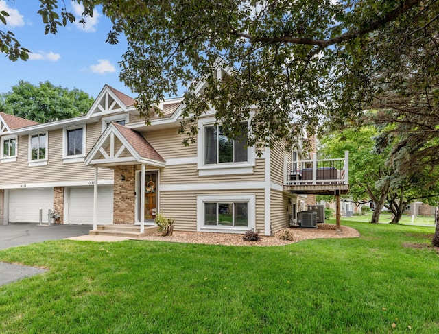 14258 Towers Ln, Eden Prairie, MN 55347 - raised ranch with asphalt driveway, a front lawn, and a garage