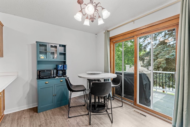 14258 Towers Ln, Eden Prairie, MN 55347 - dining area with a chandelier and light wood-type flooring