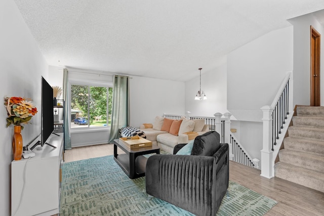 14258 Towers Ln, Eden Prairie, MN 55347 - living room with wood finished floors, a chandelier, vaulted ceiling, and a textured ceiling