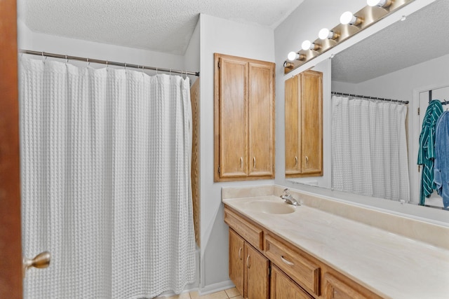 14258 Towers Ln, Eden Prairie, MN 55347 - bathroom with vanity, a textured ceiling, and tile patterned floors