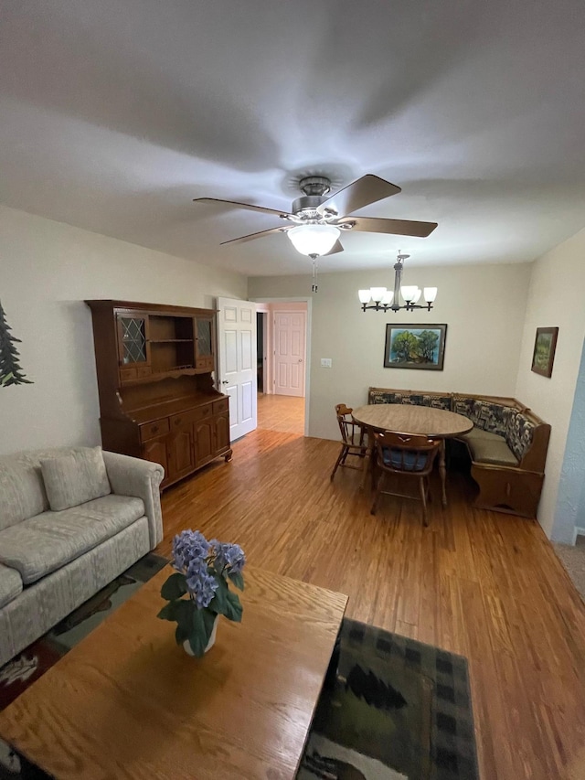38481 County Highway 41, Star Lake Twp, MN 56528 - living area with a ceiling fan, wood finished floors, and a chandelier