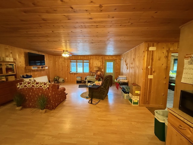 1951 Wolf Lake Dr SE, Bemidji, MN 56601 - living room featuring wooden walls, wooden ceiling, wood finished floors, ceiling fan, and a fireplace