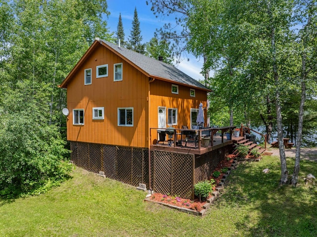 43784 Spider Lake Rd, Marcell, MN 56657 - back of house featuring a yard, a wooden deck, and roof with shingles