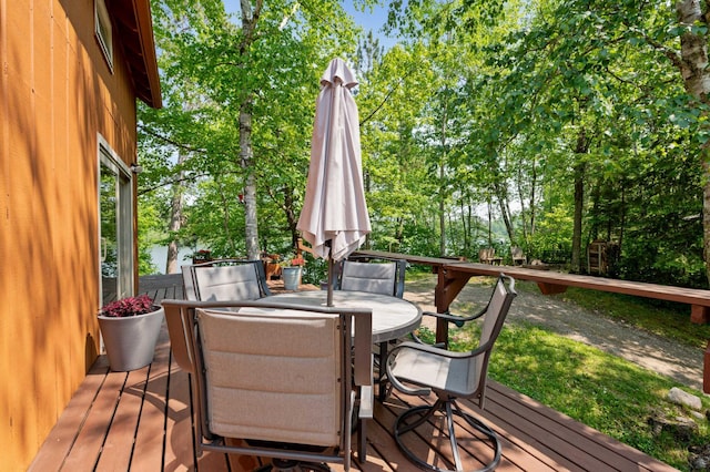 43784 Spider Lake Rd, Marcell, MN 56657 - wooden deck featuring outdoor dining space and view of scattered trees