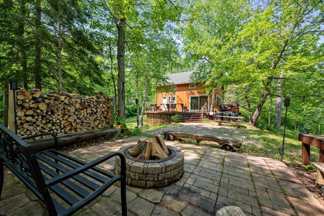 43784 Spider Lake Rd, Marcell, MN 56657 - view of patio / terrace with an outdoor fire pit and a wooden deck