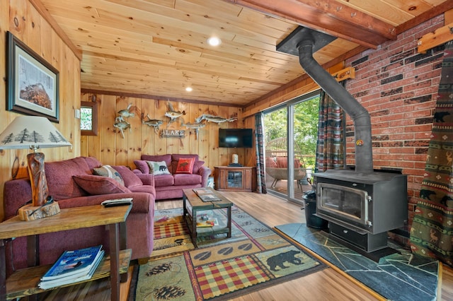 43784 Spider Lake Rd, Marcell, MN 56657 - living area with a wood stove, wood ceiling, wood finished floors, and wood walls