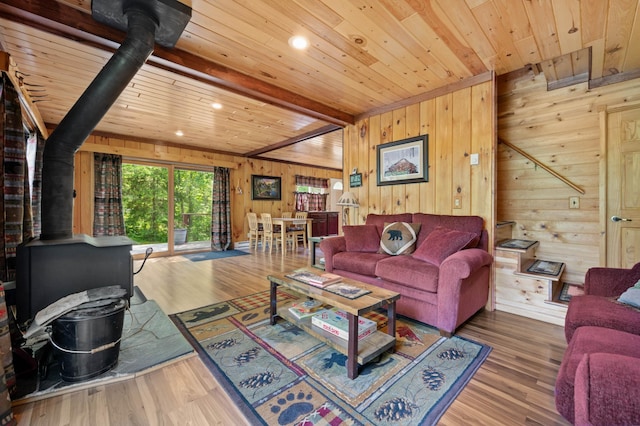 43784 Spider Lake Rd, Marcell, MN 56657 - living area featuring a wood stove, a wood ceiling with exposed beams, wood walls, wood finished floors, and recessed lighting
