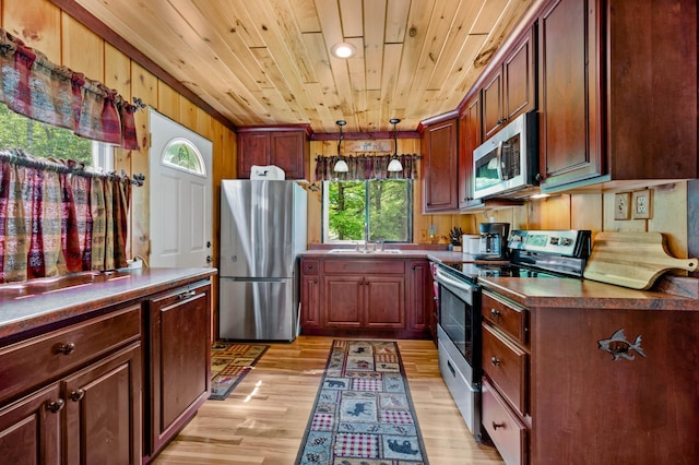 43784 Spider Lake Rd, Marcell, MN 56657 - kitchen with stainless steel appliances, wood ceiling, light wood-type flooring, dark countertops, and hanging light fixtures