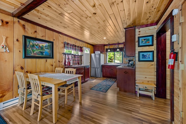 43784 Spider Lake Rd, Marcell, MN 56657 - dining area featuring wooden walls, wood ceiling, and dark wood-style flooring