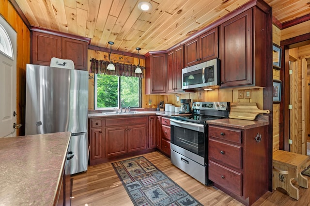 43784 Spider Lake Rd, Marcell, MN 56657 - kitchen with stainless steel appliances, wood ceiling, light wood finished floors, dark countertops, and pendant lighting