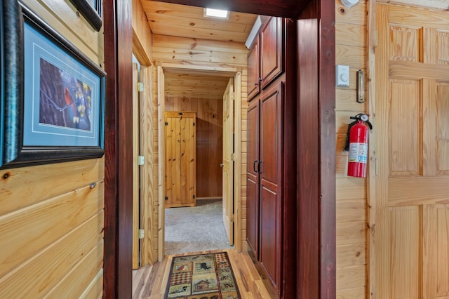 43784 Spider Lake Rd, Marcell, MN 56657 - corridor featuring wood walls, light wood-type flooring, and wooden ceiling