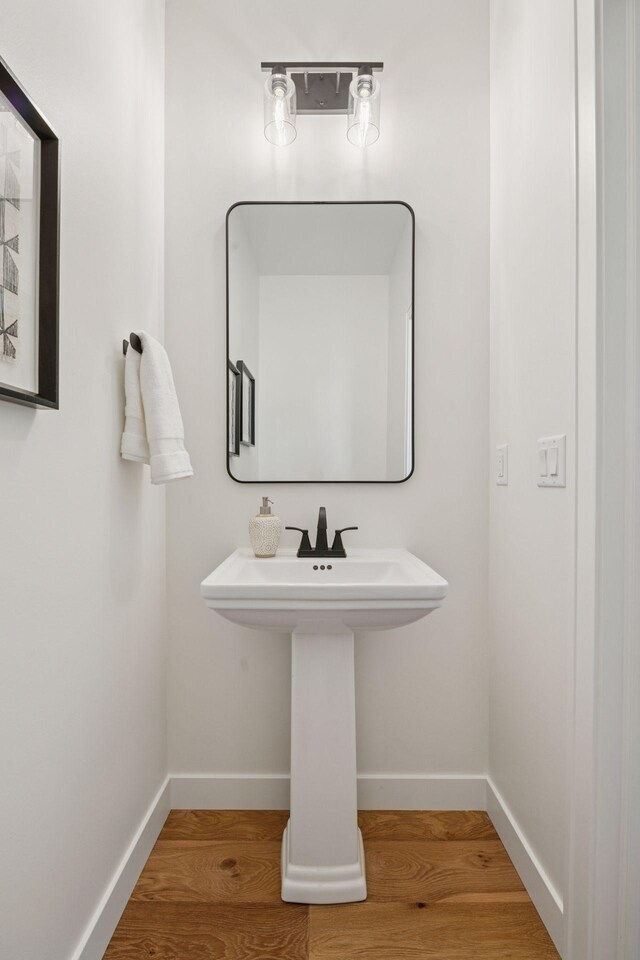 5043 42nd Ave S, Minneapolis, MN 55417 - bathroom featuring baseboards and wood finished floors