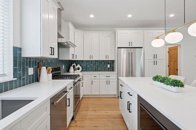 5043 42nd Ave S, Minneapolis, MN 55417 - kitchen featuring appliances with stainless steel finishes, light countertops, white cabinets, pendant lighting, and tasteful backsplash