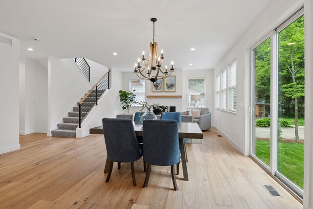 5043 42nd Ave S, Minneapolis, MN 55417 - dining area featuring a chandelier, light wood finished floors, stairs, recessed lighting, and a fireplace