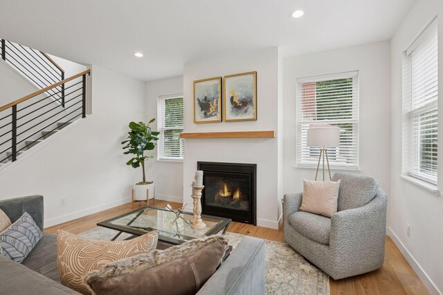 5043 42nd Ave S, Minneapolis, MN 55417 - living area featuring wood finished floors, a glass covered fireplace, stairs, and recessed lighting
