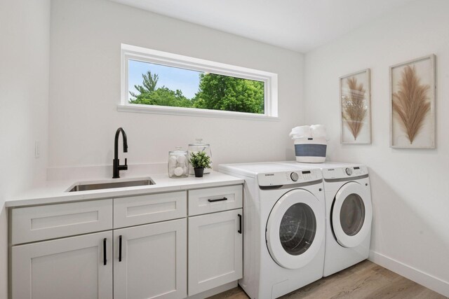 5043 42nd Ave S, Minneapolis, MN 55417 - laundry area featuring cabinet space, washer and clothes dryer, and light wood finished floors
