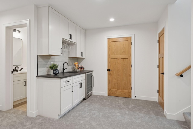 5043 42nd Ave S, Minneapolis, MN 55417 - kitchen with light colored carpet, beverage cooler, backsplash, white cabinets, and recessed lighting