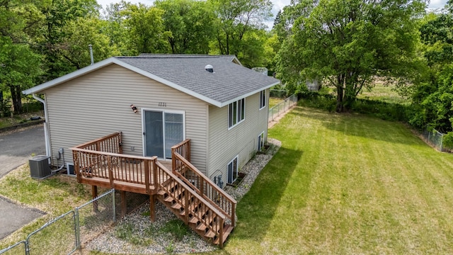 1731 Park Ave NW, Bemidji, MN 56601 - rear view of property featuring roof with shingles, a fenced backyard, a deck, and view of wooded area