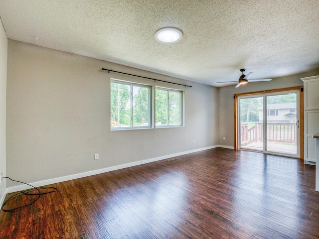 1731 Park Ave NW, Bemidji, MN 56601 - unfurnished room with healthy amount of natural light, a textured ceiling, dark wood-style floors, and a ceiling fan