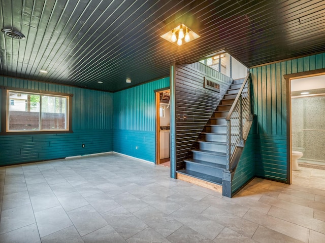 1731 Park Ave NW, Bemidji, MN 56601 - unfurnished living room featuring stairs, wood walls, and wooden ceiling