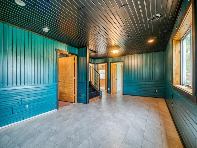 1731 Park Ave NW, Bemidji, MN 56601 - empty room featuring stairs, wood walls, and a smoke detector