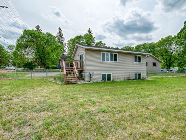 1731 Park Ave NW, Bemidji, MN 56601 - rear view of house with stairway, a wooden deck, a fenced backyard, and a gate
