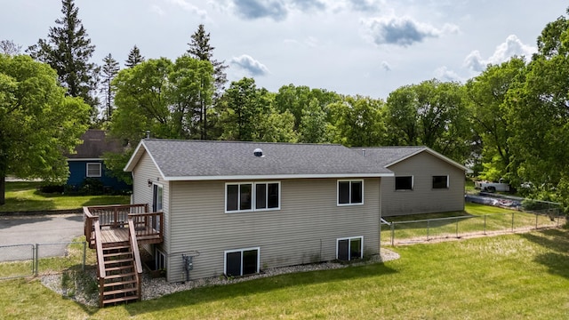 1731 Park Ave NW, Bemidji, MN 56601 - rear view of property with a deck, stairs, a fenced backyard, and a shingled roof