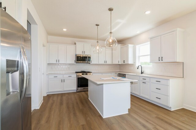 14551 74th St NE, Otsego, MN 55330 - kitchen with appliances with stainless steel finishes, wood finished floors, light countertops, white cabinetry, and recessed lighting