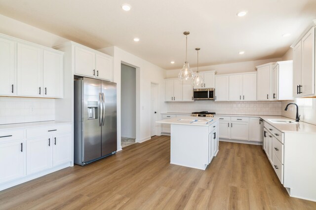 14551 74th St NE, Otsego, MN 55330 - kitchen featuring stainless steel appliances, a center island, decorative backsplash, light countertops, and recessed lighting