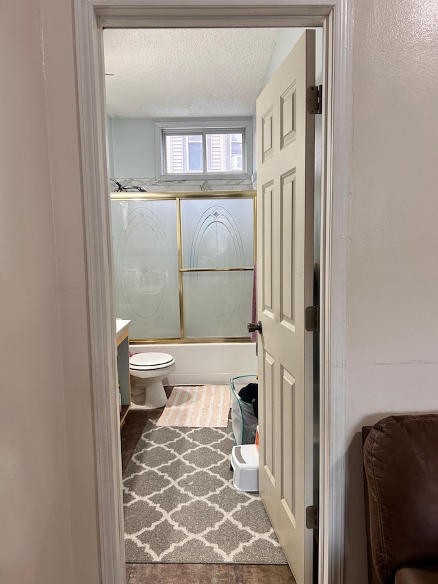328 Edmund Ave, Saint Paul, MN 55103 - bathroom with a textured ceiling, shower / bath combination with glass door, and vanity