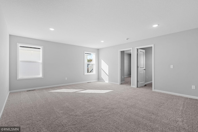 6801 104th St S, Cottage Grove, MN 55016 - empty room featuring light colored carpet and recessed lighting