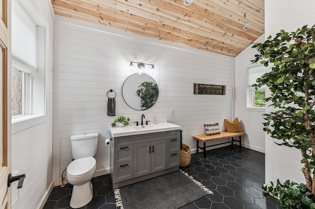 47235 184th Ave, Mcgregor, MN 55760 - bathroom featuring vanity, tile patterned flooring, wood ceiling, vaulted ceiling, and wooden walls
