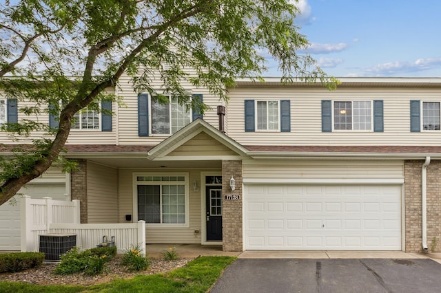 17128 Olson St NW Unit 2508, Elk River, MN 55330 - traditional-style house with an attached garage, asphalt driveway, and brick siding