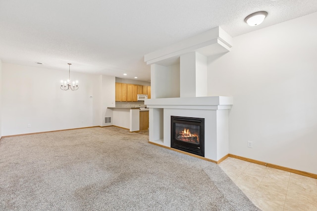 17128 Olson St NW Unit 2508, Elk River, MN 55330 - unfurnished living room with a glass covered fireplace, a chandelier, light carpet, and recessed lighting
