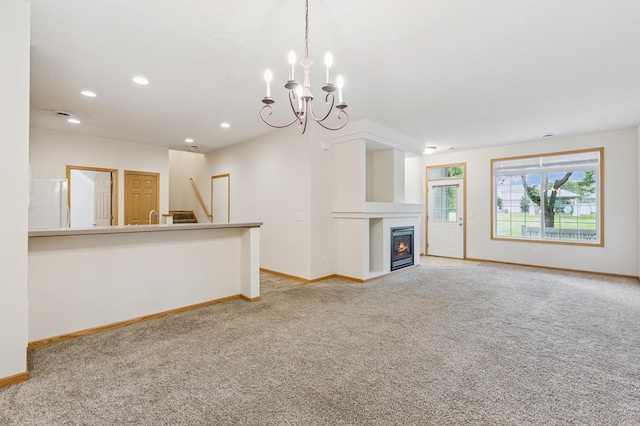 17128 Olson St NW Unit 2508, Elk River, MN 55330 - unfurnished living room featuring light carpet, a chandelier, recessed lighting, and a warm lit fireplace
