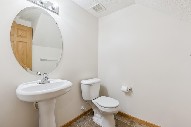 17128 Olson St NW Unit 2508, Elk River, MN 55330 - bathroom with a textured ceiling, vaulted ceiling, and tile patterned flooring